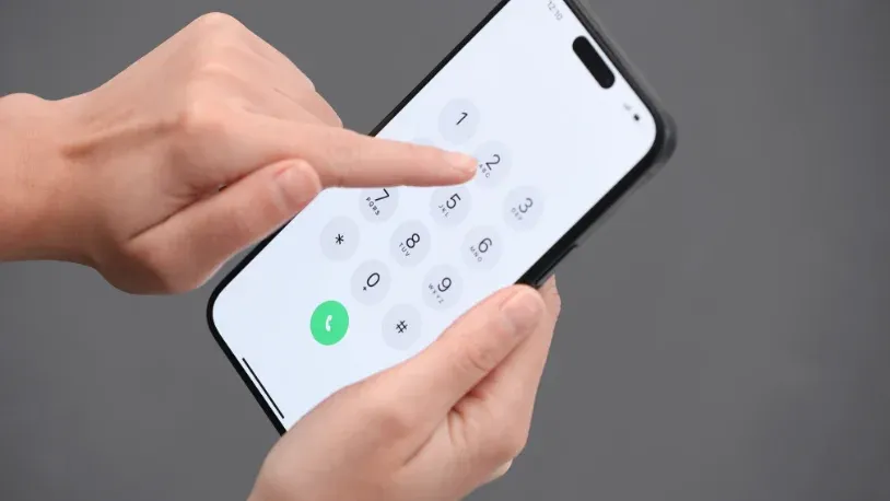 Hands holding a cell phone