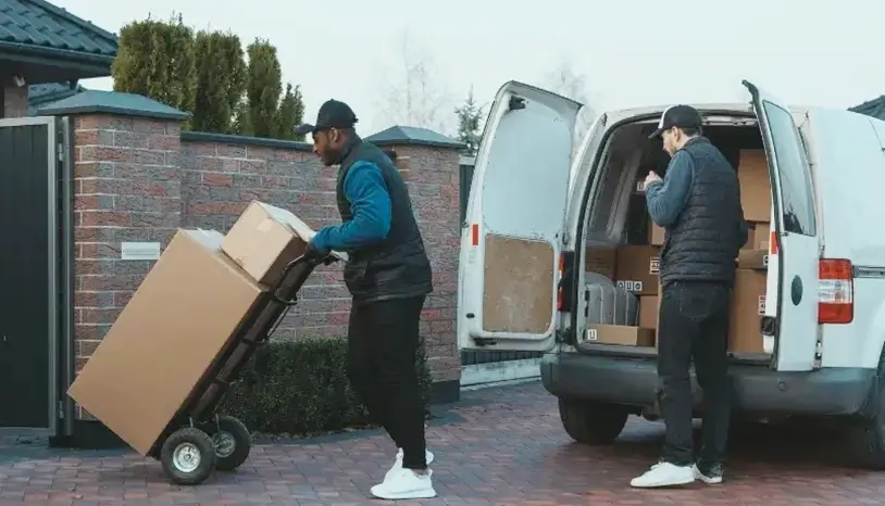 Two men delivering parcel to a house