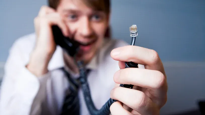 Man holding a disconnected phone line