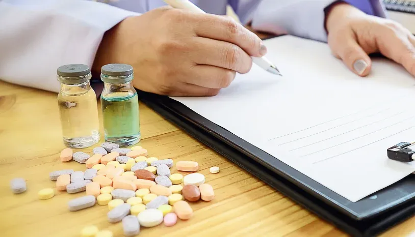 Pharmacist with medicine bottles and tablets