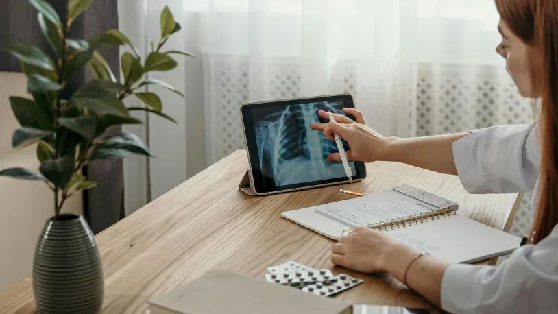 doctor looking at xray file on the tablet