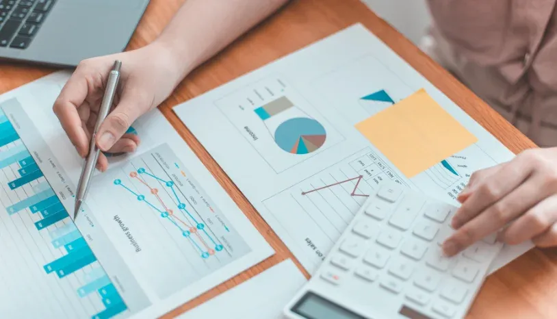 A woman going through sheets of statistics for business growth  